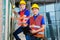 Asian worker controlling building on construction site