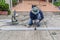 asian worker with machine cutting metal and welded steel to create a roof, local labor construction concept