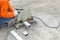 asian worker with machine cutting metal and welded steel to create a roof, local labor construction concept