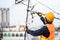 Asian worker repairing an old TV antenna on rooftop