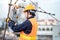 Asian worker repairing an old TV antenna on rooftop