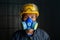 Asian worker wear wears a respirator in a smokey, toxic atmosphere. Image show the importance of protection readiness and safety
