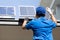 Asian workers technicians man installing solar photovoltaic panels for LED lamps on the roof of the house.