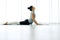 Asian yogi woman practicing yoga concept, stretching in Cobra exercise, Bhujangasana pose, working out, indoor