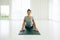 Asian yogi woman practicing yoga concept, stretching in Cobra exercise, Bhujangasana pose, working out, indoor full length, white