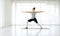 Asian yogi woman practicing yoga, standing in Warrior two exercise, Virabhadrasana II pose on mat