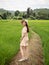 Asian young adult walking on ridge in green rice field. Ecology travel in Nan, Thailand. person standing in wide rice terrace.