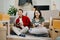 Asian young attractive couple man and woman use tablet and smartphone online shopping furniture decorate house with carton package