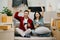 Asian young attractive couple man and woman use tablet and smartphone online shopping furniture decorate house with carton package