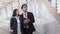 Asian young businessman and pretty woman look over