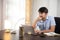 Asian young businessman smiling typing on laptop Happy businessman working on strategy at home office