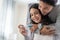 Asian young couple feeling happy after look at positive pregnancy test. Beautiful loving woman surprises boyfriend with good news