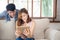 Asian young couple relax looking tablet entertainment on internet together on sofa at home