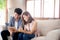 Asian young couple relax looking tablet entertainment on internet together on sofa at home