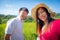 Asian young couple are smiling and making photo for a memories of vacation together in the meadows and mountains