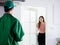 Asian young customer girl open door welcome and waiting for delivery man who wears green jacket uniform with cap sending parcel to