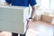 Asian young delivery man holding and carrying two cardbox standing in workplace