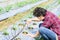 Asian young farmer using drip irrigation system