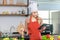 Asian young female chef housewife wears white tall cook hat and apron learning cooking homemade food meal online via touchscreen