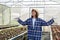 Asian young female farmer showed signs of joy and feeling refreshed in the greenhouse full of organic vegetables