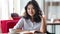 Asian young female student enjoying free time sitting with book and cup of coffee