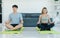Asian young fit male female husband and wife in sportswear sport bra legging sneakers sitting closed eyes meditating on yoga mat