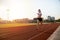 Asian Young fitness woman runner running on stadium track -healthy lifestyle and sport concepts