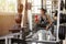 asian young fitness woman with towel listening music with earphones holding water bottle relaxing sitting on Weight lifting