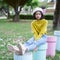 Asian young girl sitting at play ground wear yellow swater and jean
