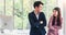 Asian young handsome business man talk with business woman so funny. Good relationship in working. Causing a good atmosphere at