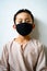 Asian young kid is wearing hygienic reusable face mask to prevent the virus