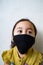 Asian young kid is wearing hygienic reusable face mask to prevent the virus