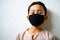 Asian young kid is wearing hygienic reusable face mask to prevent the virus