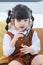 Asian young lonely little cute preschooler daughter girl playing doctor patient using stethoscope  on cozy sofa in living room at