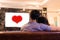 Asian young lovers watching television on sofa. Couples and Relax concept. Holiday and vacation concept. Night dating and