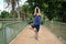 Asian young man in navy blue sportwear standing and doing yoga for meditation for create concentration and calm the mind.