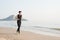 Asian young man running alone at the beach in Morning
