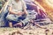 Asian young man sitting in the fire outside the tent, lonely camp in the forest