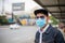 Asian Young man standing in the city and wearing protection mask on face for protection air pollution, particulates and for