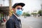 Asian Young man standing in the city and wearing protection mask on face for protection air pollution, particulates and for