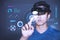 The Asian young man with virtual reality glasses. experiences VR hololens headset in studio with advanced technology