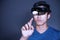 The Asian young man with virtual reality glasses. experiences VR hololens headset in studio with advanced technology