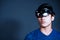 The Asian young man with virtual reality glasses. experiences VR hololens headset in studio with advanced technology