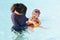 Asian young mother and cute eight month baby enjoy swimming pool