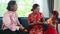 Asian young mother and daughter bring auspicious oranges to wish grandmother on Chinese New Year