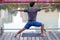 The Asian young strong muscular man doing yoga exercise by the lake in the park in the evening sunset time