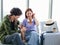 Asian young traveler lover couple siting on terminal chair seat with luggage suitcase, having conversation, laughing and having