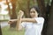 Asian young woman doing stretching exercising at park. Healthy Concept