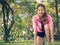 Asian young woman on mark to set ready for jogging exercise to build up her body on glass in warm light morning.