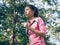 Asian young woman on mark to set ready for jogging exercise to build up her body on glass in warm light morning.